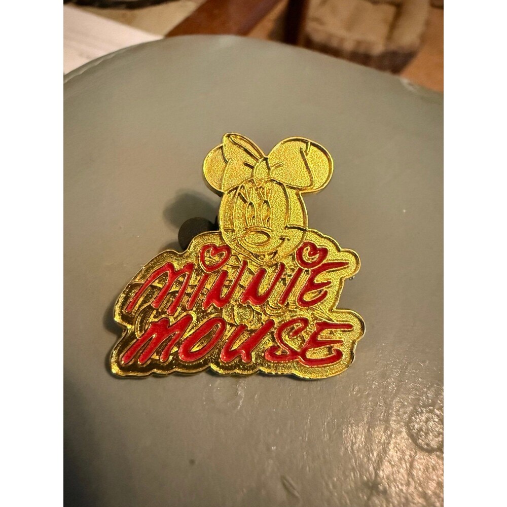 Disney Pin featuring Minnie Mouse's signature